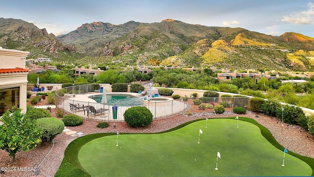 exterior space featuring a fenced in pool, a mountain view, a fenced backyard, and a patio