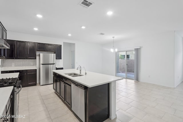 kitchen featuring visible vents, light countertops, a sink, and stainless steel appliances