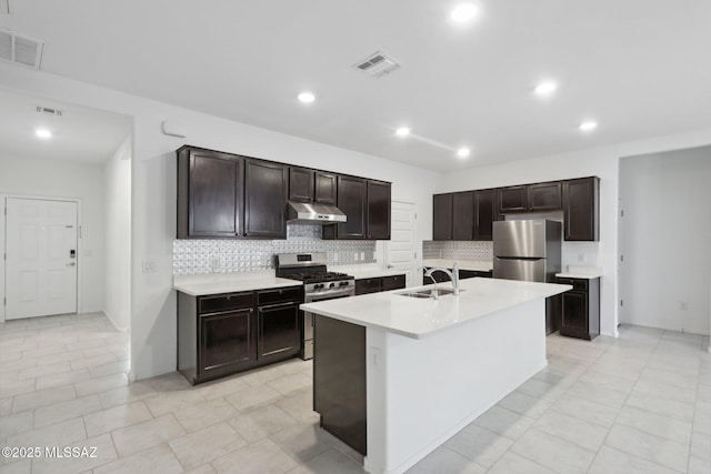 kitchen featuring a sink, visible vents, under cabinet range hood, and appliances with stainless steel finishes