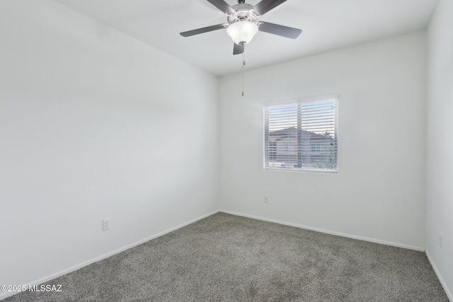 spare room with baseboards, carpet floors, and a ceiling fan