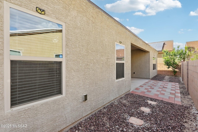 exterior space featuring a fenced backyard, stucco siding, and a patio area