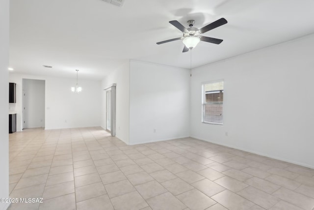 empty room with ceiling fan with notable chandelier