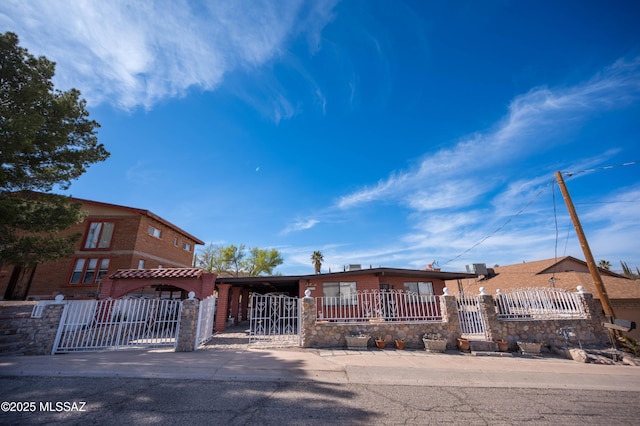 view of front of property featuring a fenced front yard, a gate, and stone siding