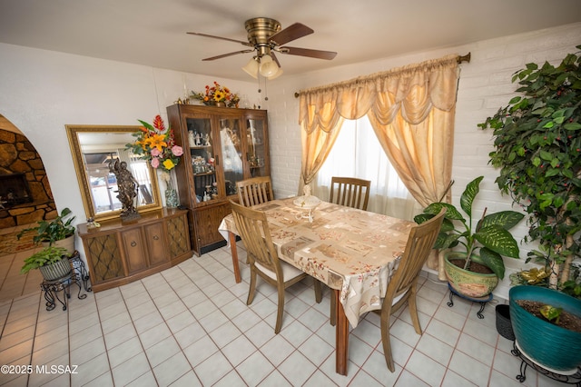 dining area with light tile patterned floors and a ceiling fan