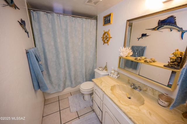bathroom with visible vents, tile patterned floors, toilet, and vanity