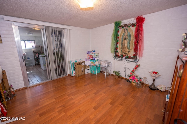 playroom featuring wood finished floors and a textured ceiling
