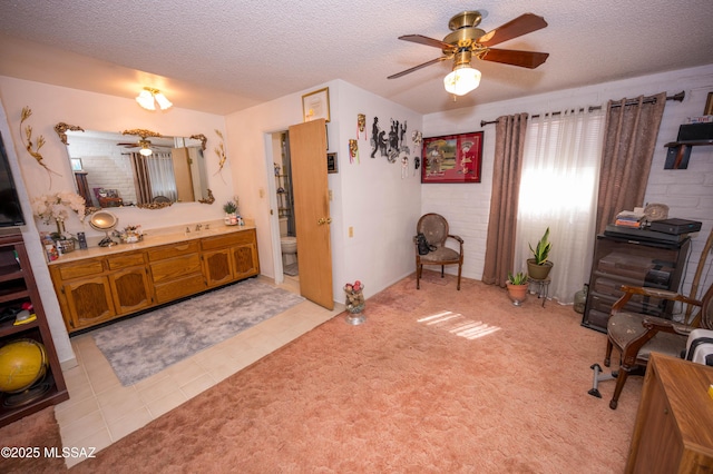 bathroom featuring a textured ceiling, toilet, tile patterned floors, vanity, and a ceiling fan