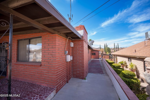 view of property exterior with brick siding