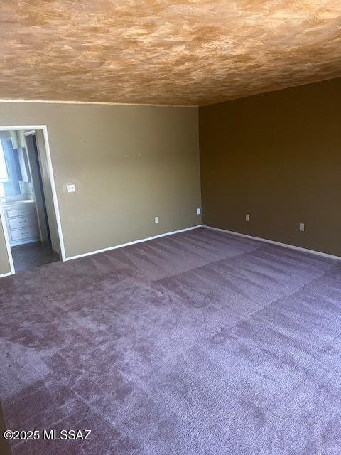 empty room with dark colored carpet