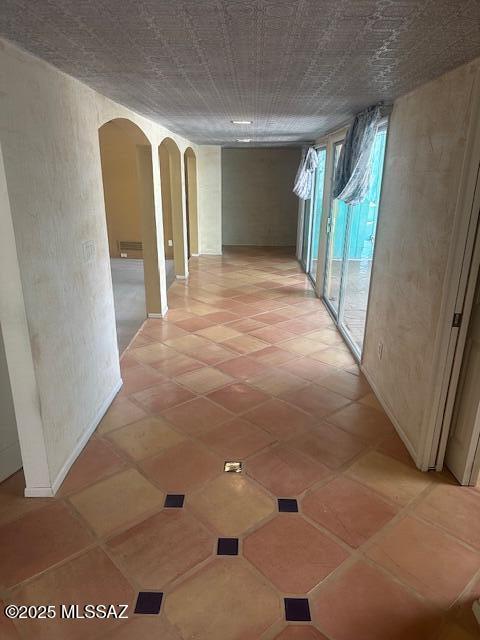 corridor featuring arched walkways