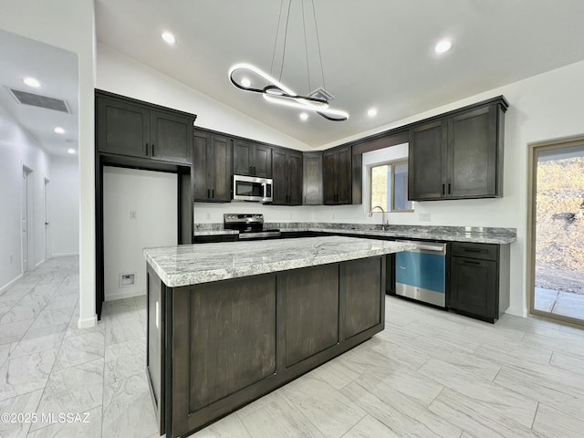kitchen featuring visible vents, a center island, vaulted ceiling, appliances with stainless steel finishes, and marble finish floor