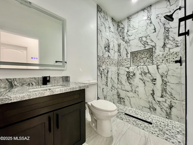 full bathroom featuring vanity, toilet, marble finish floor, and a marble finish shower