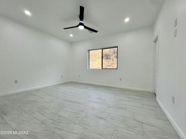 spare room with recessed lighting, a ceiling fan, baseboards, and marble finish floor