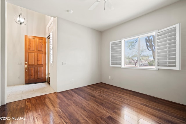 spare room with ceiling fan and wood finished floors