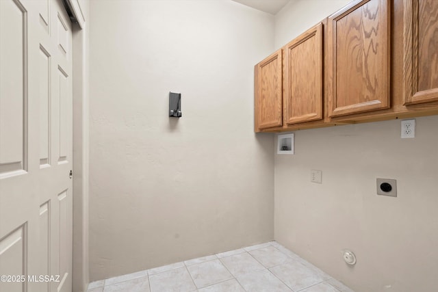 clothes washing area featuring hookup for an electric dryer, cabinet space, light tile patterned flooring, and hookup for a washing machine