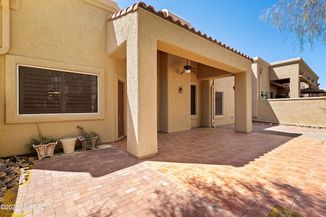 exterior space featuring ceiling fan and fence