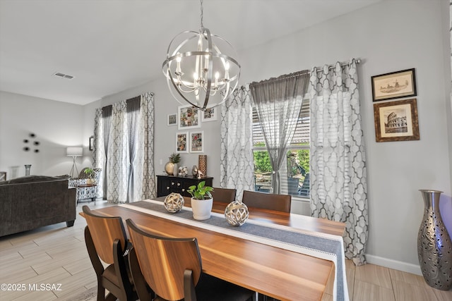 8874 W Saguaro Skies Rd, Marana, AZ 85653 - dining area with a chandelier, wood tiled floors, and baseboards