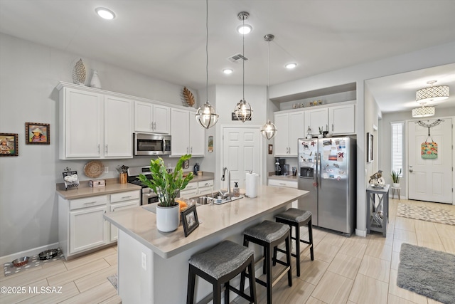 8874 W Saguaro Skies Rd, Marana, AZ 85653 - kitchen featuring stainless steel appliances, a sink, white cabinetry, and recessed lighting