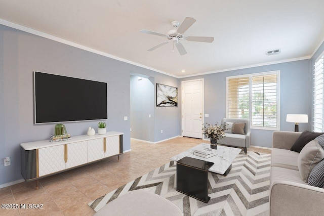living room featuring baseboards, ornamental molding, and light tile patterned flooring