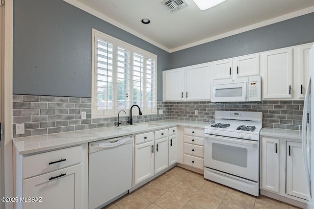 kitchen featuring tasteful backsplash, visible vents, crown molding, white appliances, and a sink