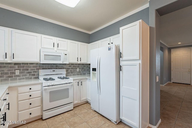 kitchen featuring tasteful backsplash, white appliances, white cabinetry, and ornamental molding