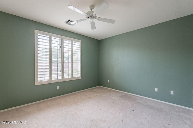 spare room featuring visible vents, baseboards, ceiling fan, and carpet floors