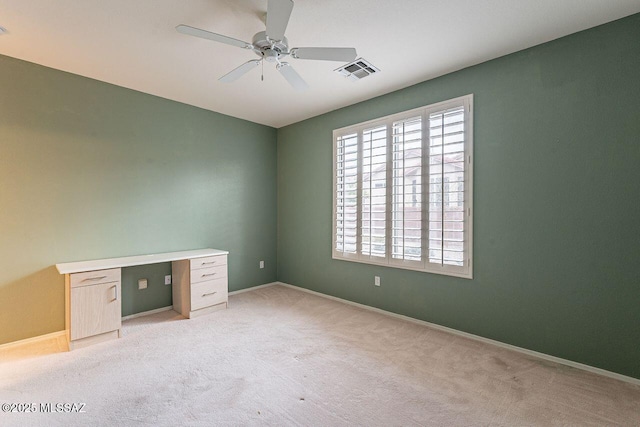interior space featuring visible vents, light colored carpet, baseboards, and ceiling fan
