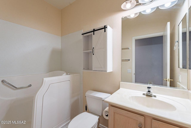 bathroom featuring vanity and toilet