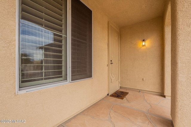 doorway to property with stucco siding