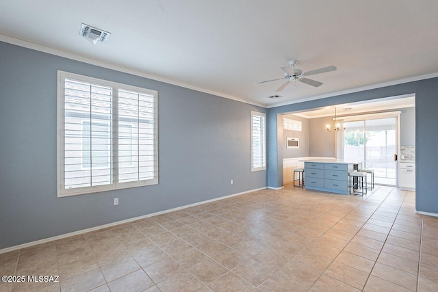 empty room featuring crown molding, ceiling fan with notable chandelier, visible vents, and baseboards