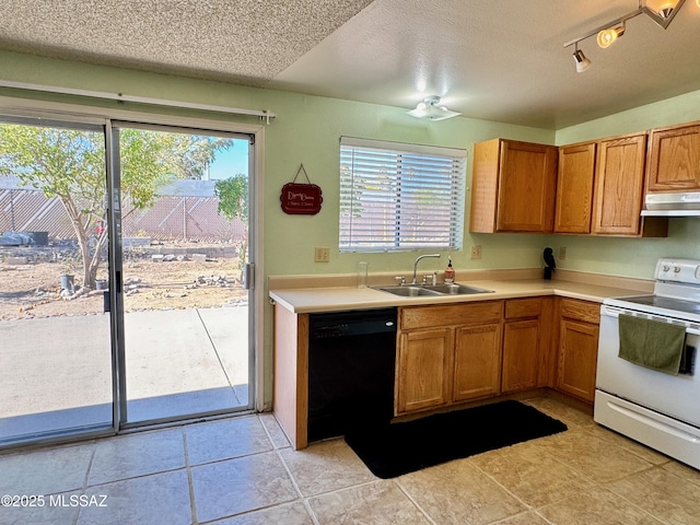 kitchen featuring a sink, dishwasher, a textured ceiling, under cabinet range hood, and white electric range
