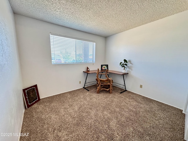 home office with carpet floors and a textured ceiling