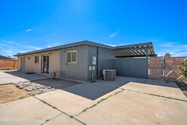 back of house featuring a gate, a patio area, fence, and cooling unit