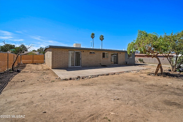 back of house with a patio, a fenced backyard, and brick siding