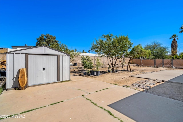 exterior space with a fenced backyard, an outdoor structure, and a shed