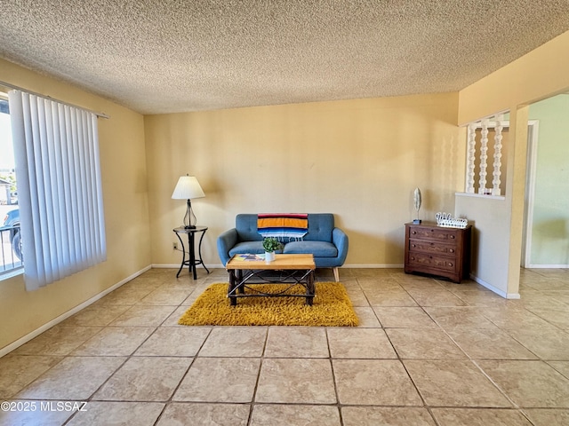 living area with a textured ceiling and tile patterned flooring