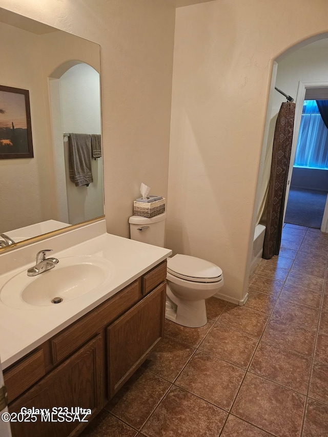 bathroom featuring toilet, tile patterned floors, and vanity
