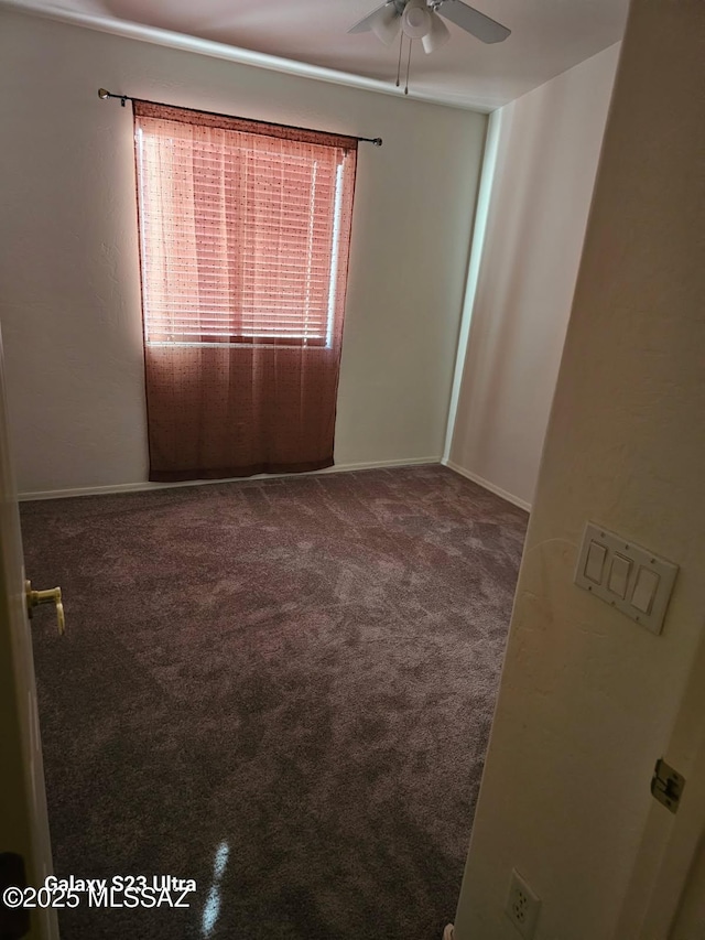 unfurnished room featuring a ceiling fan and carpet