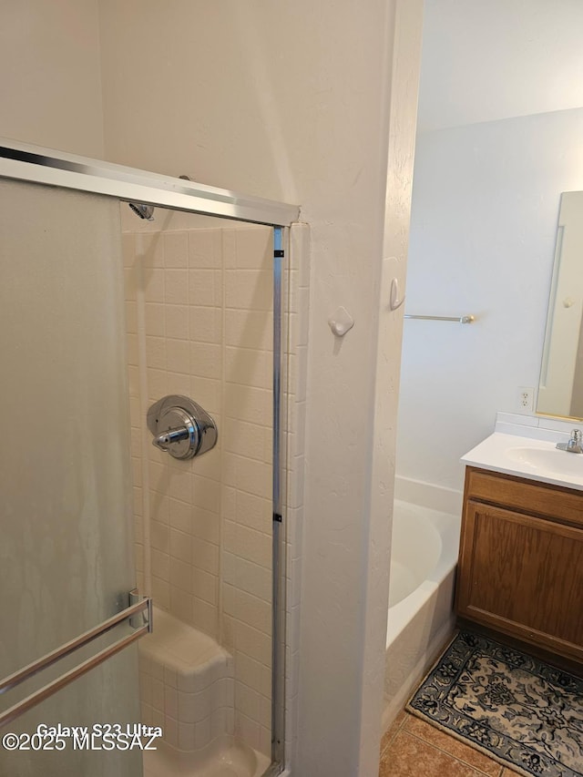 bathroom with tile patterned flooring, vanity, a bath, and a shower stall