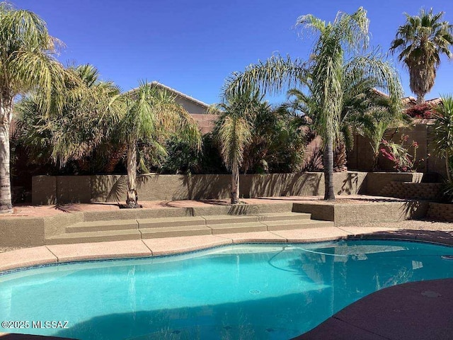 view of swimming pool featuring a fenced in pool and fence