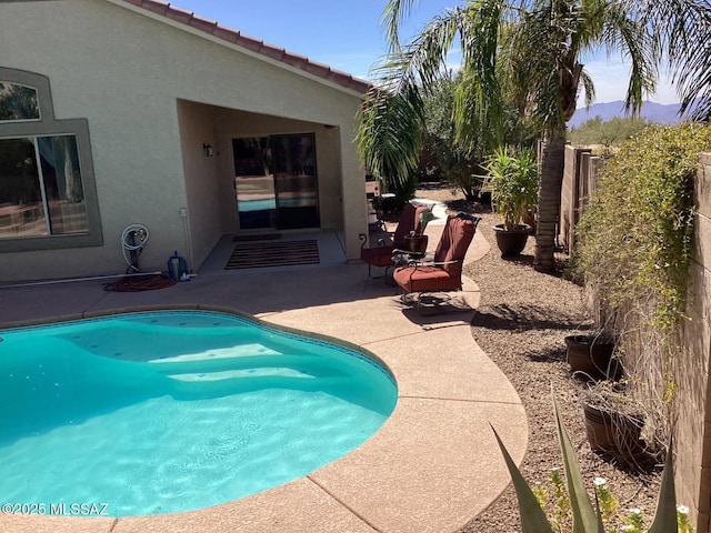 view of swimming pool with a fenced in pool, fence, and a patio