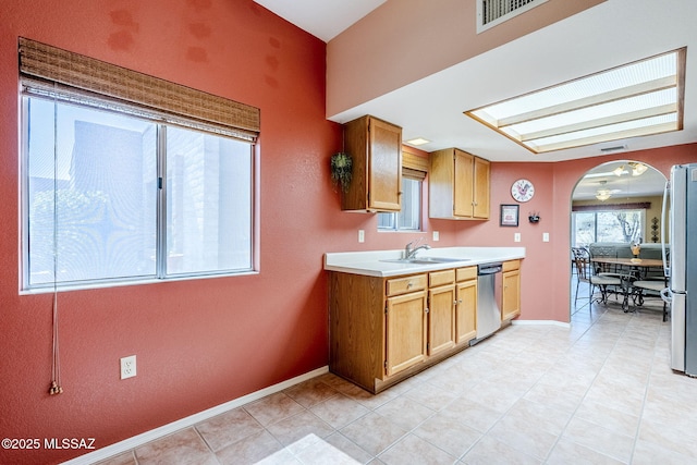 kitchen featuring visible vents, baseboards, light countertops, appliances with stainless steel finishes, and a sink