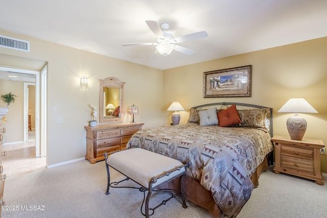 bedroom with baseboards, light carpet, visible vents, and a ceiling fan