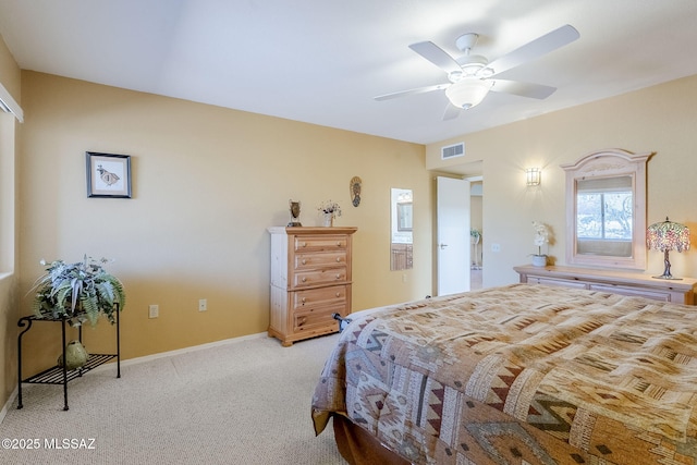 bedroom with visible vents, baseboards, light colored carpet, and a ceiling fan