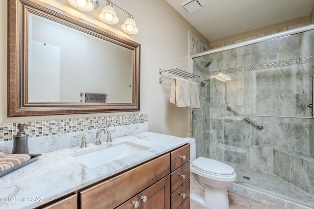 bathroom with tasteful backsplash, visible vents, toilet, a stall shower, and vanity