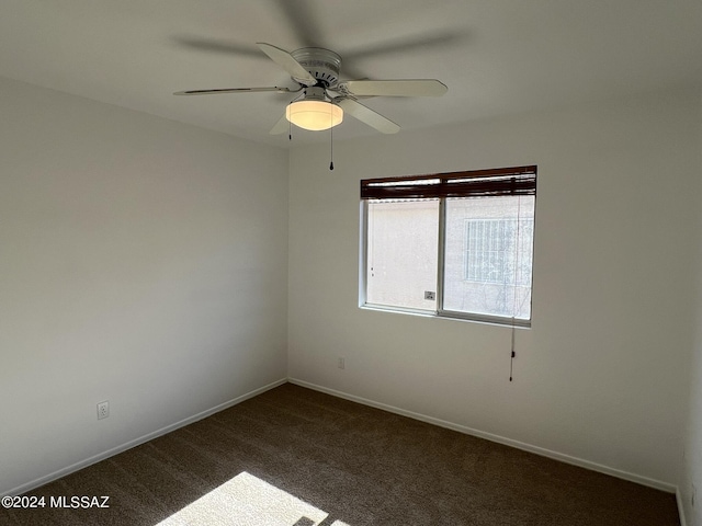 empty room featuring baseboards, ceiling fan, and carpet flooring