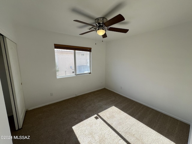 unfurnished bedroom featuring carpet flooring, baseboards, and a ceiling fan