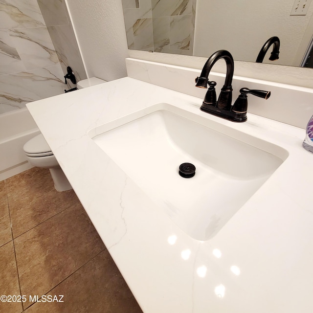 room details featuring vanity, toilet, a shower, and a bathtub