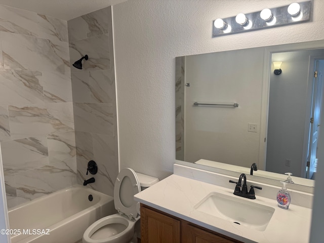 bathroom featuring toilet, shower / washtub combination, vanity, and a textured wall