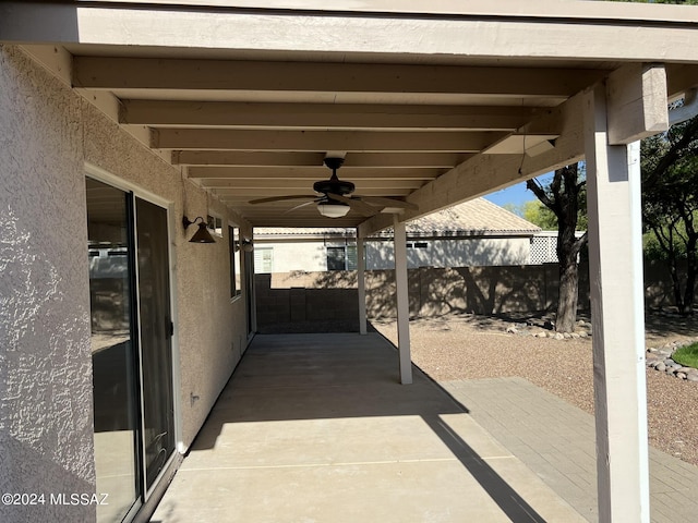 view of patio featuring a ceiling fan and fence